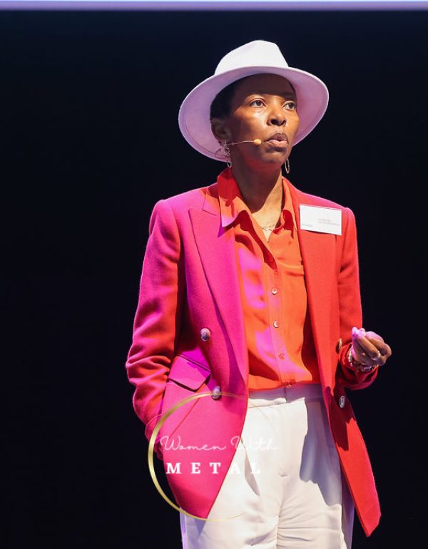 Lily Samuels delivering a presentation on women’s health and performance at a Women With Metal Conference.